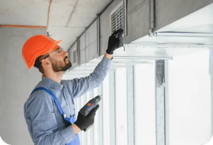 Technician servicing a ventilation system, illustrating thermal meter application